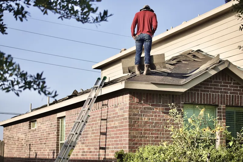 Professional roofer working on a residential roof in Carderock Springs
